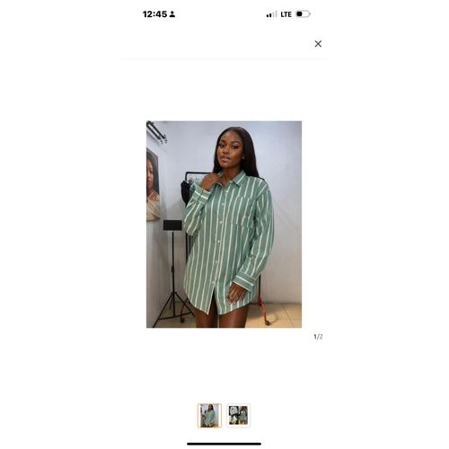 Woman’s oversize striped shirt buttoning down