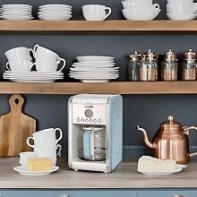 a coffee maker and teapot on a kitchen counter.
