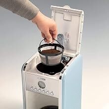 a hand is opening a coffee maker.