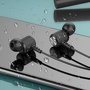 Black in-ear headphones with textured metal bodies and thin cables, displayed on a water-droplet covered surface with teal and gray backdrop.