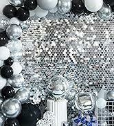 a black and white birthday party with a silver and black balloon arch