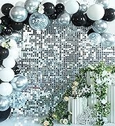 a black and white balloon arch with a floral garland