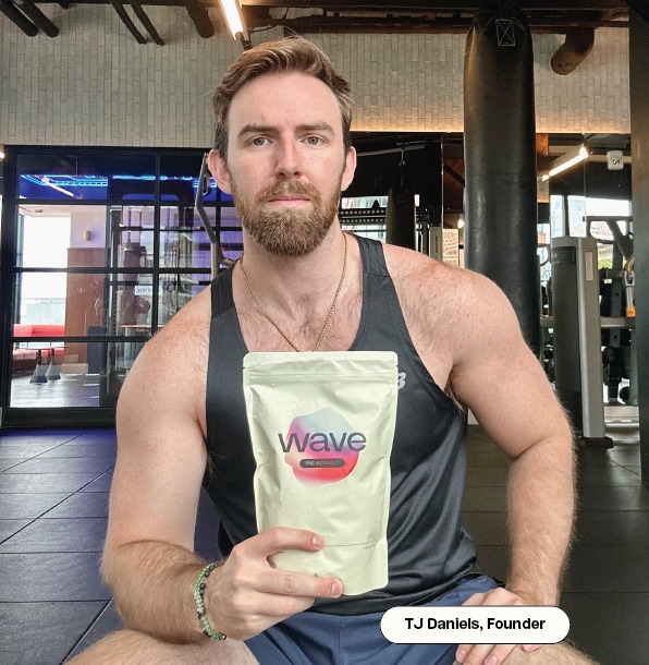 Man in gym holding a package labeled 'Wave' with building and equipment in the background.