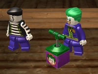 The Joker readying an explosive charge in Lego Batman 2: DC Super Heroes for PS Vita