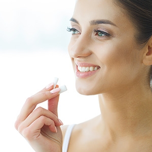 woman holding a chewing gum