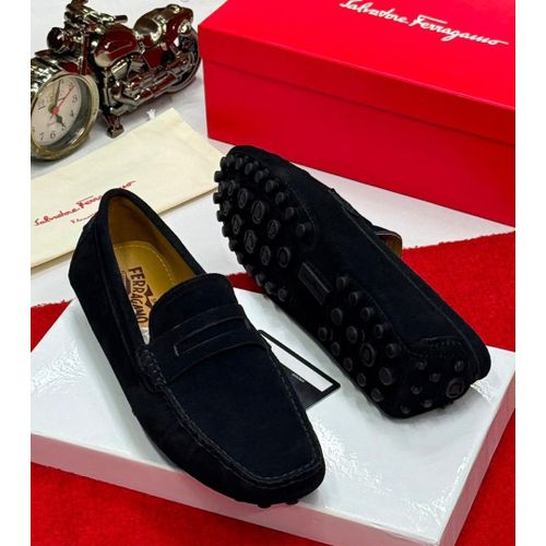 Black slip-on penny loafer design.
