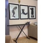 Generic black metal ironing board with a retractable iron rest.