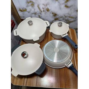 Uakeen granite cookware set available in a cream color with grey handles.