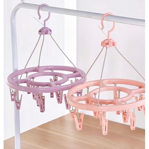A Round Clothes Drying Rack with 12 Clips, Made of Plastic, Designed to Hang Underwear And Socks, Featuring a 360-Degree Windproof Design. It Serves As a Multifunctional Storage Rack for Clothing And Is Suitable for Organizing Items in a Wardrobe